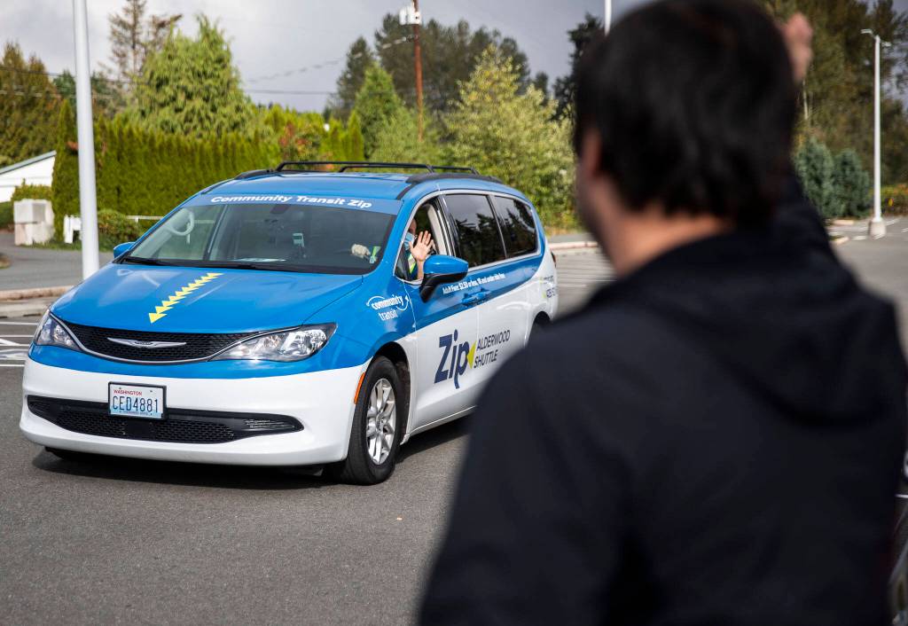 A Zip Alderwood shuttle driver pulls into the Swamp Creek Park and Ride on Sunday in Lynnwood. (Olivia Vanni / The Herald)