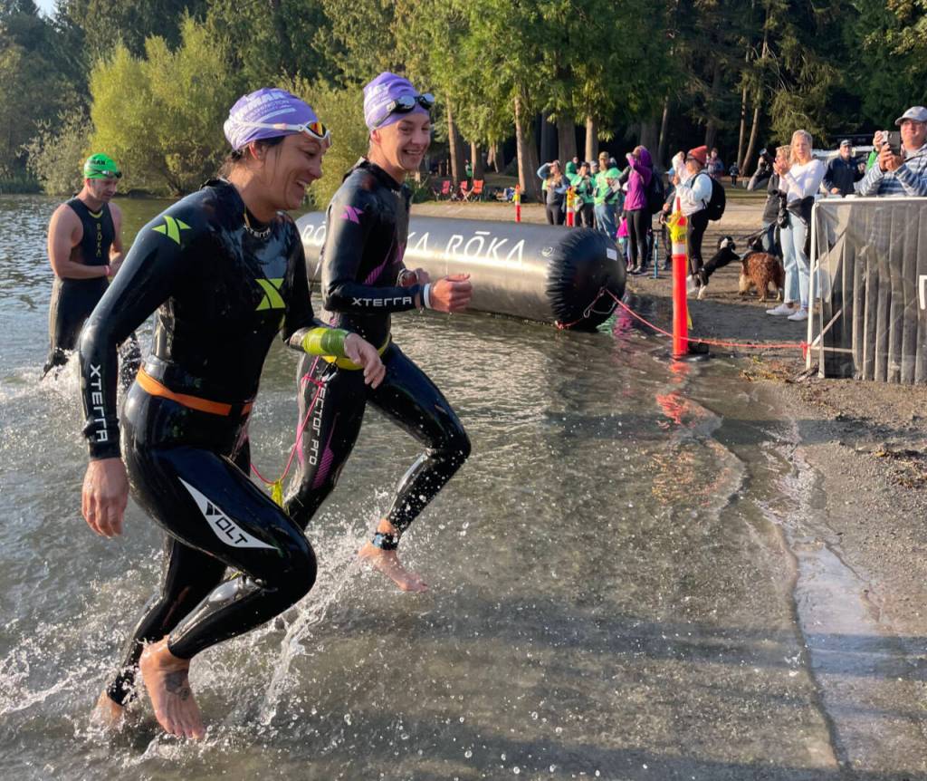 Misty Johnson (right) is tethered to her guide, Amy Lewandowski, during in the Ironman 70.3 Washington half-ironman triathlon last month in Maple Valley. (Photo provided by Andrea Skorheim)