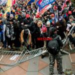 Federal agents say photo shows Tucker Weston leading a crowd breaking a metal barricade to advance on the U.S. Capitol on Jan. 6, 2021. (U.S. Attorneys Office for the District of Columbia)