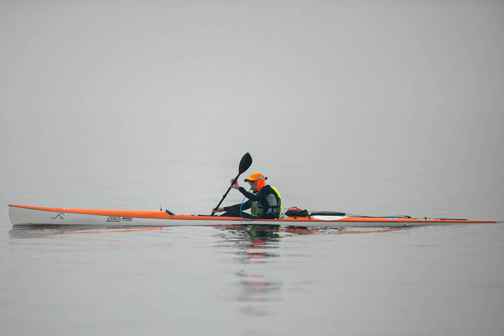 A man kayaks in the Possession Sound through a thick haze of wildfire smoke on Thursday, in Mukilteo. (Ryan Berry / The Herald)