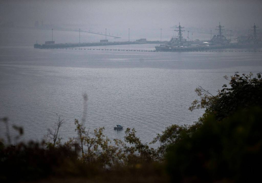 The edge of Naval Station Everett is visible through smoke on Thursday, Oct. 20, 2022 in Snohomish, Washington. (Olivia Vanni / The Herald)