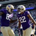 Washington tight end Devin Culp (83) celebrates with running back Cameron Davis (22) after Davis scored against Arizona during the first half on an NCAA football game, Saturday, Oct. 15, 2022, in Seattle. (AP Photo/John Froschauer)