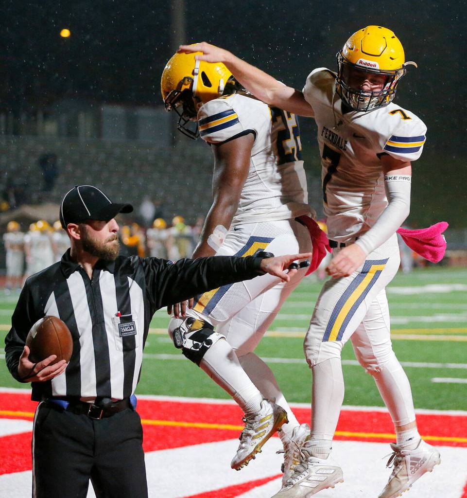 Ferndales Zach Nielson and Isaiah Carlson celebrate a touchdown against Stanwood Friday, Oct. 21, 2022, at Stanwood High School in Stanwood, Washington. (Ryan Berry / The Herald)