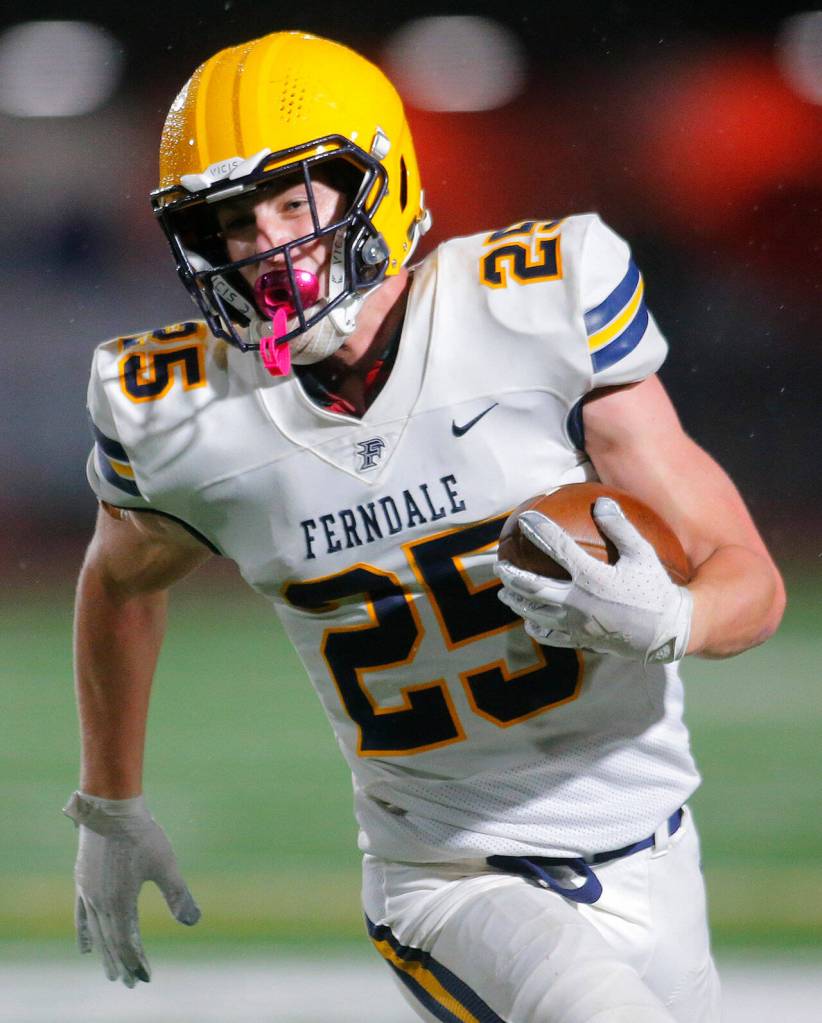 Ferndales Conner Walcker turns the corner and heads for the sideline against Stanwood Friday, Oct. 21, 2022, at Stanwood High School in Stanwood, Washington. (Ryan Berry / The Herald)