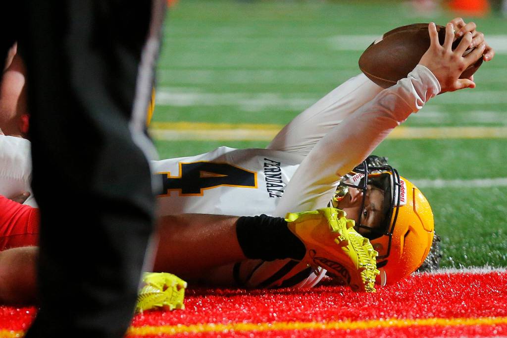 Ferndales Bishop Ootsey looks for the touchdown call from a ref after sneaking the ball from inside the one yard line against Stanwood Friday, Oct. 21, 2022, at Stanwood High School in Stanwood, Washington. (Ryan Berry / The Herald)