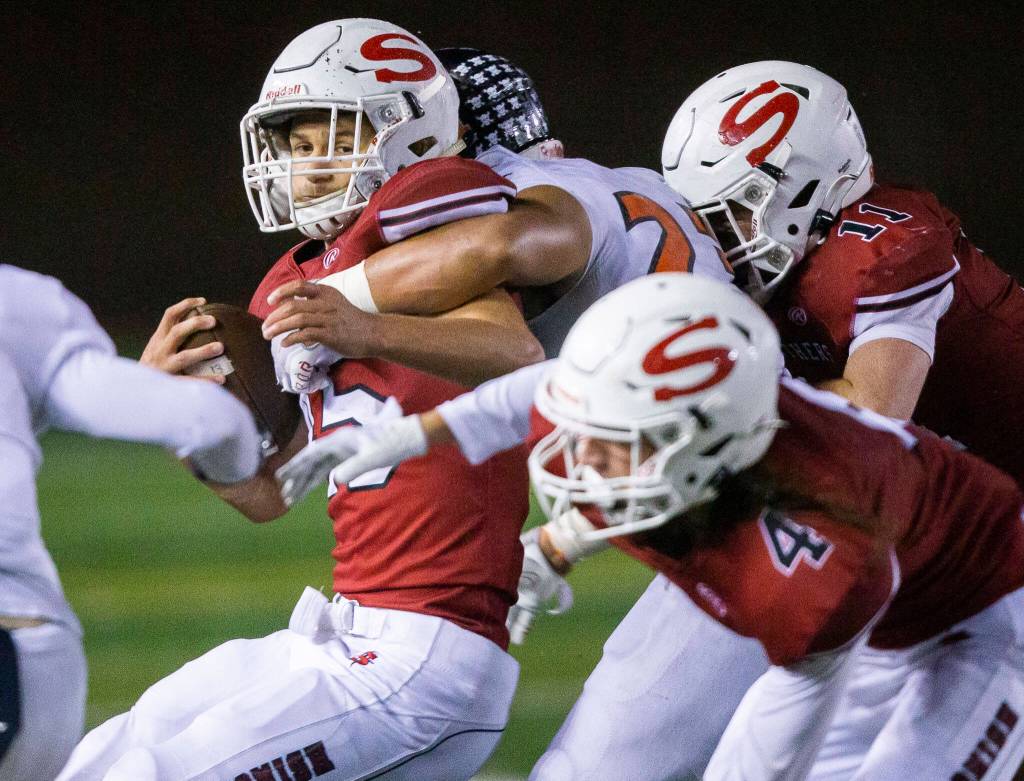 Snohomishs Caleb Podoll is tackled during a game against Monroe on Friday, Oct. 21, 2022 in Snohomish, Washington. (Olivia Vanni / The Herald)