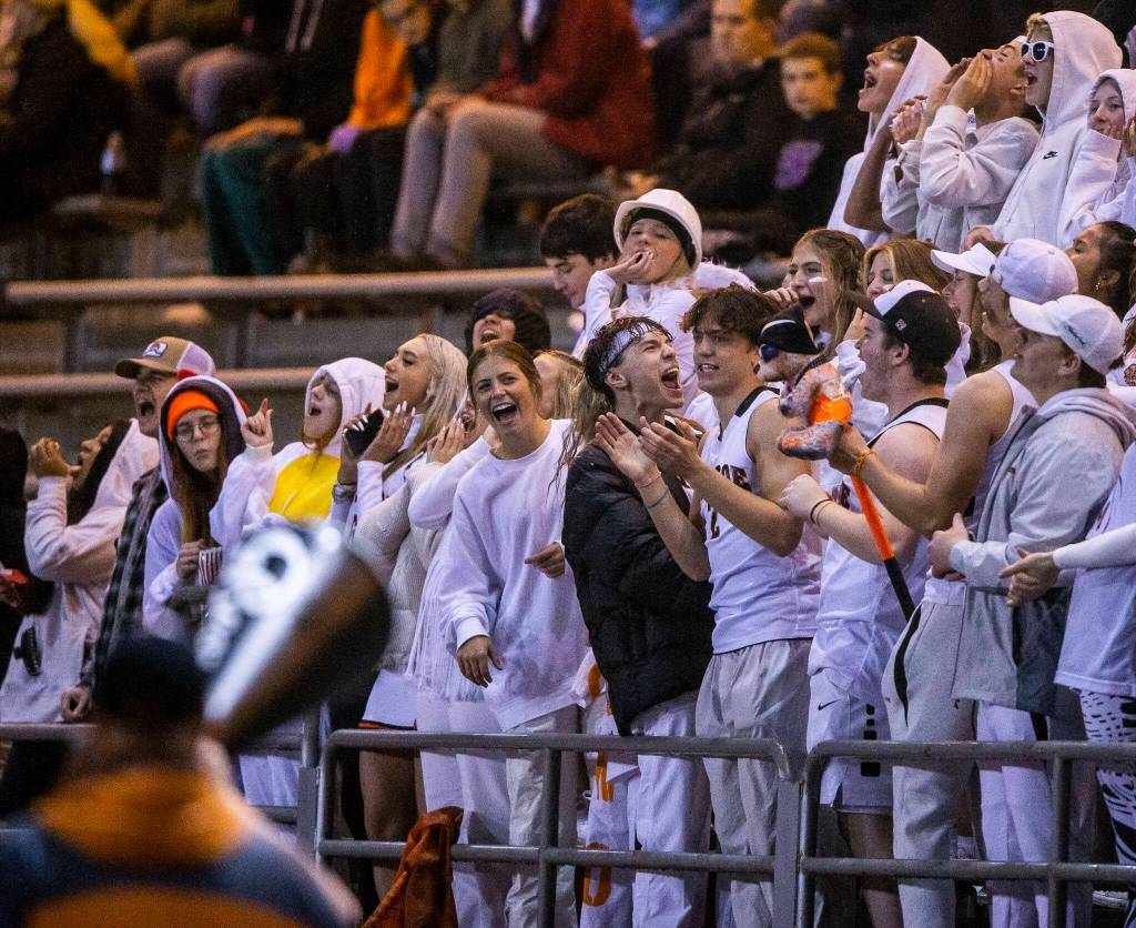 Monroe fans cheer after a touchdown during a game against Snohomish on Friday, Oct. 21, 2022 in Snohomish, Washington. (Olivia Vanni / The Herald)