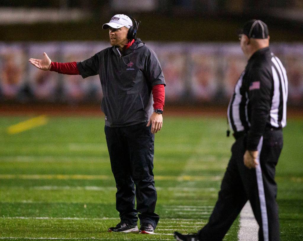 Snohomish head coach Joey Hammer talks with a referee during a game against Monroe on Friday, Oct. 21, 2022 in Snohomish, Washington. (Olivia Vanni / The Herald)