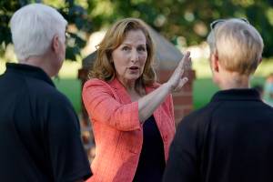 Rep. Kim Schrier, D-Wash., talks with officials from the Issaquah Police Dept., Tuesday, Aug. 2, 2022, at a community event on Election Day in Issaquah, Wash., east of Seattle. Schrier, who represents Washington state's 8th Congressional District, is facing a number of Republican challengers, including Jesse Jensen, Reagan Dunn, and Matt Larkin. (AP Photo/Ted S. Warren)