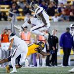 Washington tight end Devin Culp (83) hurdles California cornerback Tyson McWilliams (11) after a catch during the first half of a game Saturday night in Berkeley, Calif. (AP Photo/Godofredo A. Vásquez)