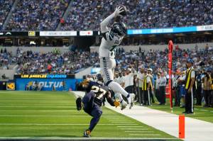 Seattle Seahawks wide receiver Marquise Goodwin (11) catches a pass for a touchdown during the first half of their game against the Los Angeles Chargers Sunday in Inglewood, Calif. Los Angeles Chargers cornerback J.C. Jackson (27) falls with an injury. (AP Photo/Marcio Jose Sanchez)