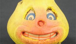 Photo Caption: Imagine seeing a glowing, grinning pear in the dark of night! This papier-mache lantern was an antique Halloween decoration.