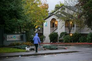 A woman walks her dog past Olin Fields Apartments, one of Security Properties Residential’s complexes in Snohomish County, on Tuesday, Oct. 25, 2022, in Everett, Washington. (Ryan Berry / The Herald)