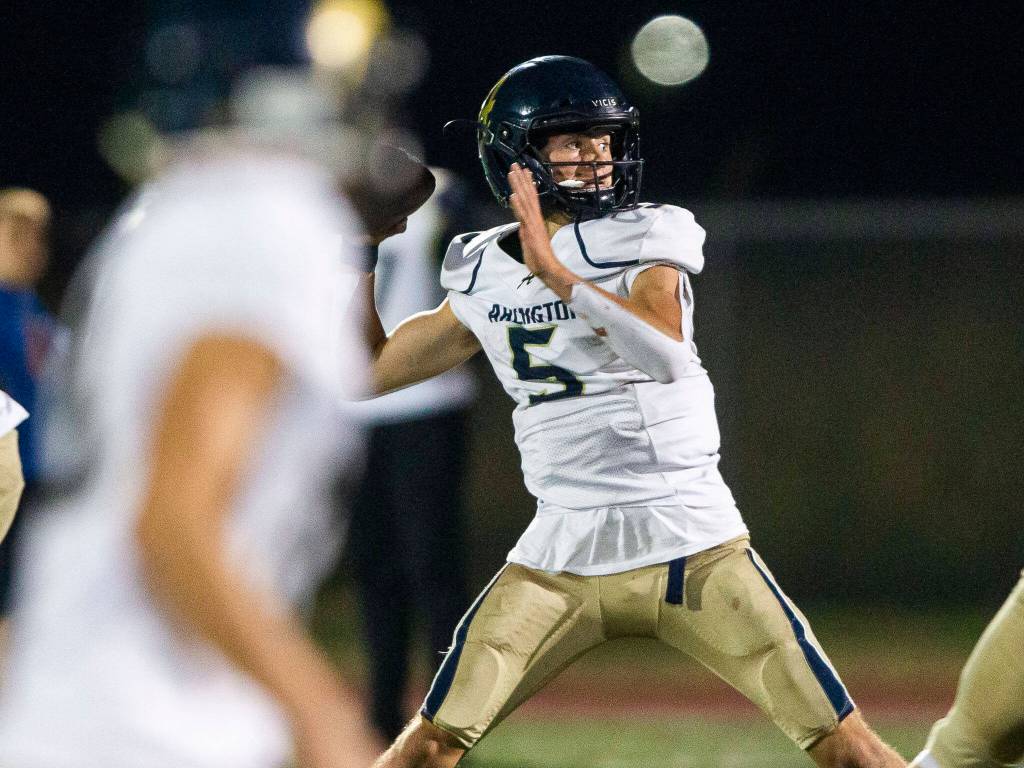 Arlingtons Jacoby Falor throws the ball during the game against Marysville Getchell on Sept. 9 in Marysville. (Olivia Vanni / The Herald)