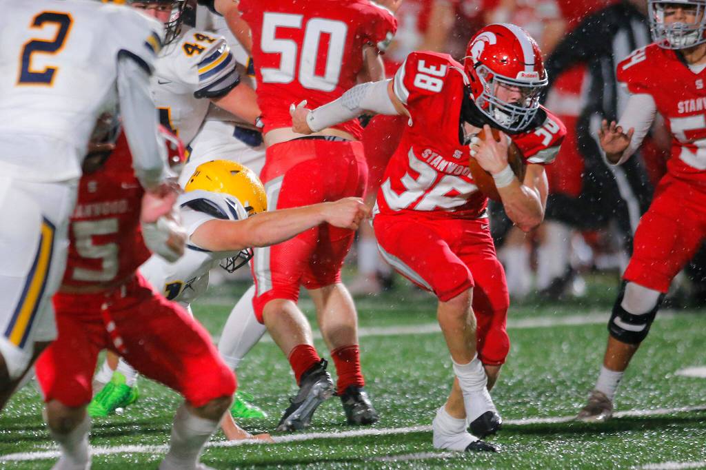Stanwoods Carson Beckt sheds one of a few would-be tacklers on his way to a 52-yard touchdown against Ferndale on Oct. 21 in Stanwood. (Ryan Berry / The Herald)