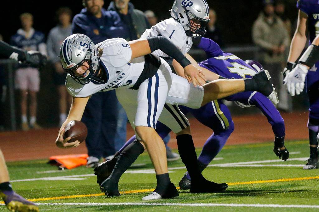 Glacier Peak quarterback River Lien reaches out and tumbles over the goal line on a second quarter touchdown against Lake Stevens on Friday, Oct. 28, 2022, at Lake Stevens High School in Lake Stevens, Washington. (Ryan Berry / The Herald)