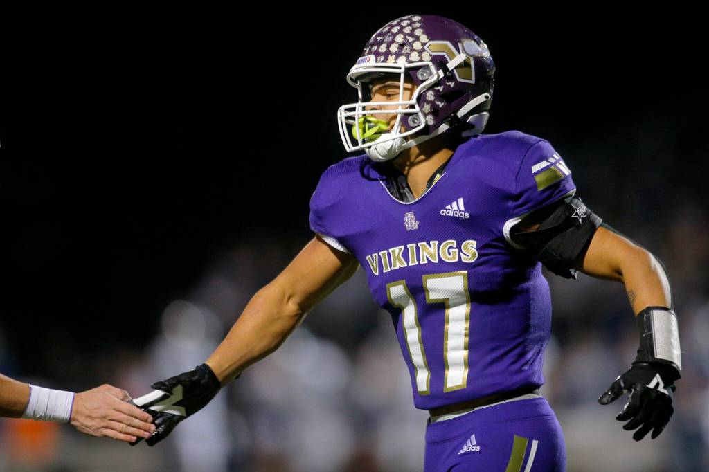 Lake Stevens Jayden Limar high fives quarterback Kolton Matson after scoring his teams first touchdown of the game against Glacier Peak on Friday, Oct. 28, 2022, at Lake Stevens High School in Lake Stevens, Washington. (Ryan Berry / The Herald)