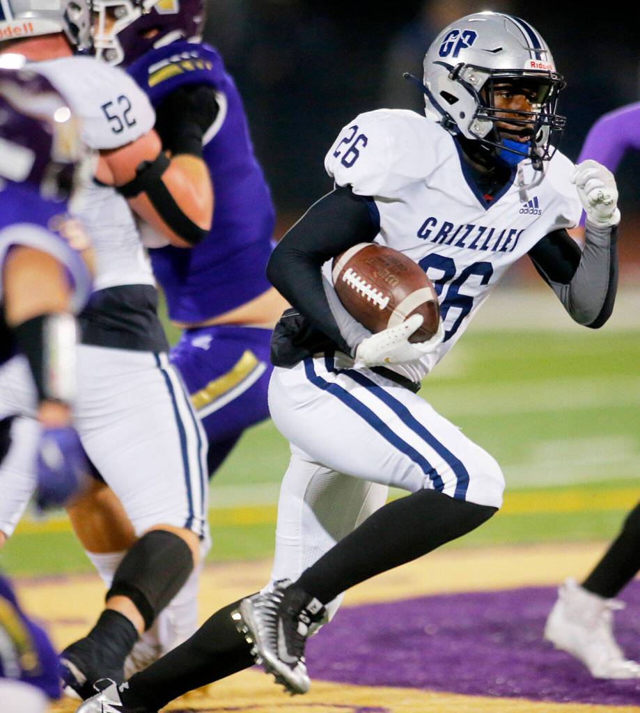 Glacier Peaks Chrisvin Bonshe splits the defense for a solid run up the middle against Lake Stevens on Friday, Oct. 28, 2022, at Lake Stevens High School in Lake Stevens, Washington. (Ryan Berry / The Herald)