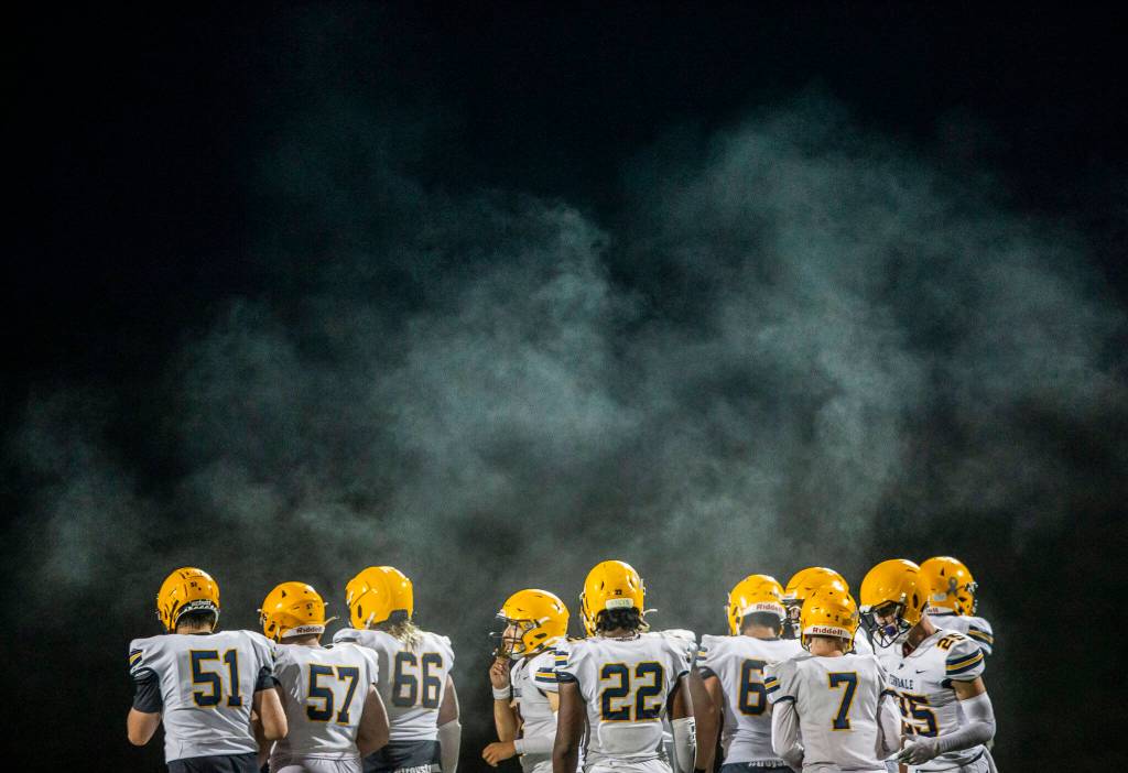 Steam rises above the Ferndale huddle during the game against Monroe on Friday, Oct. 28, 2022 in Monroe, Washington. (Olivia Vanni / The Herald)