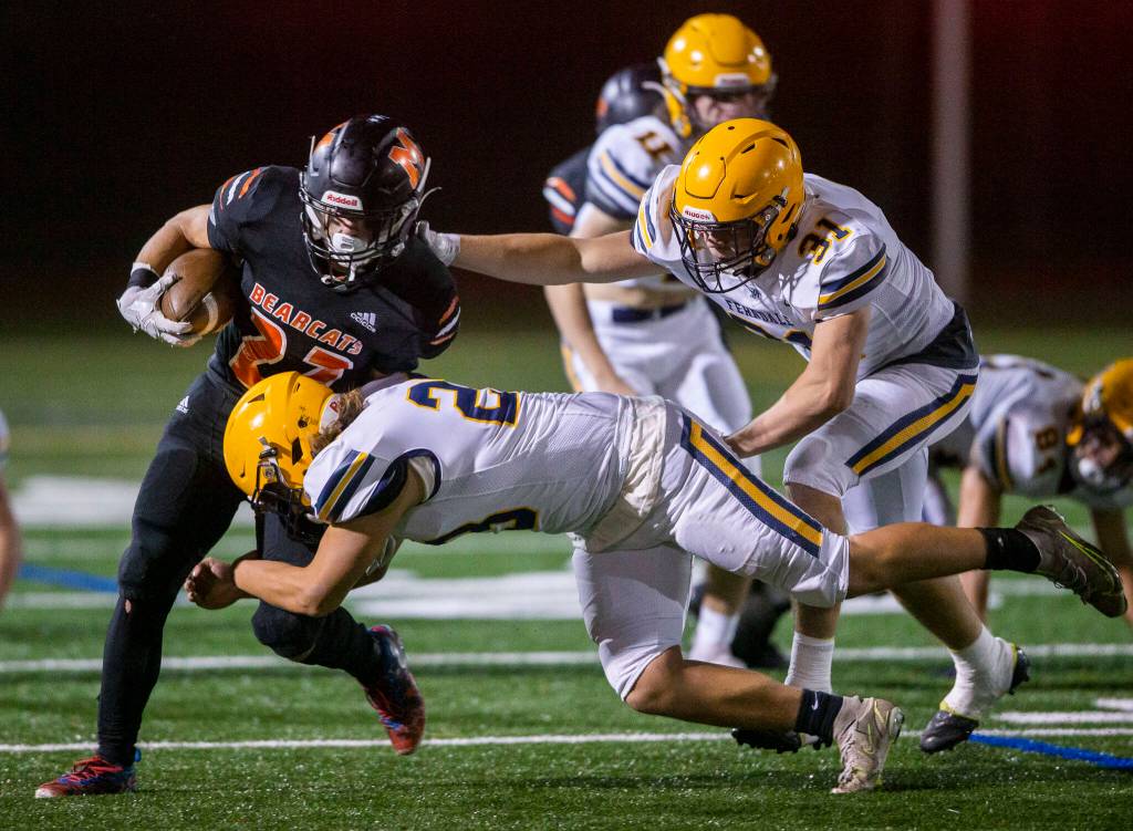 Monroes Jack Irwin escapes is tackled by multiple Ferndale players during the game on Friday, Oct. 28, 2022 in Monroe, Washington. (Olivia Vanni / The Herald)