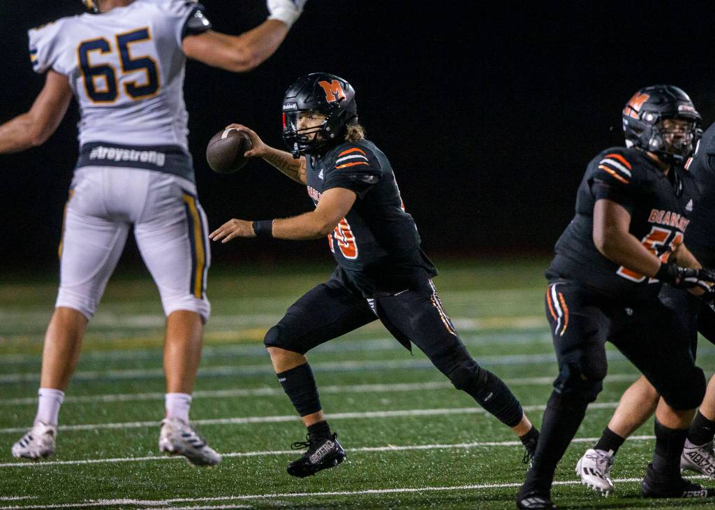Monroes Blake Springer scrambles to look for an open teammate to pass to during the game against Ferndale on Friday, Oct. 28, 2022 in Monroe, Washington. (Olivia Vanni / The Herald)