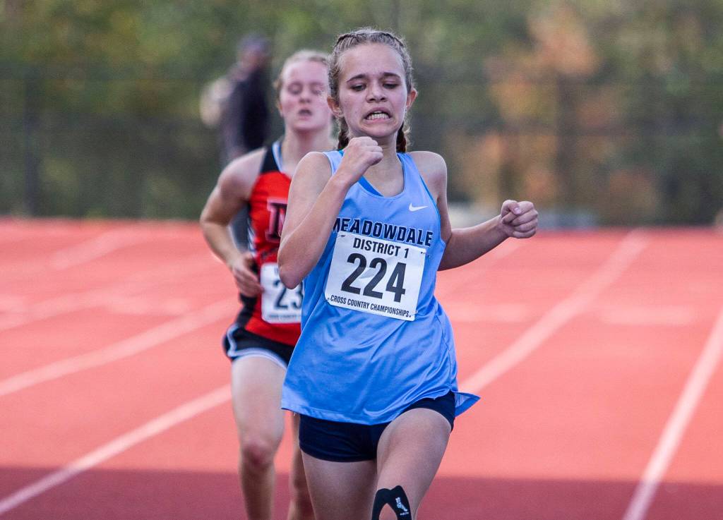 Meadowdales Payton Conover crosses the finish line to get third in the 3A Girls District Cross Country championship race on Saturday, Oct. 29, 2022 in Arlington, Washington. (Olivia Vanni / The Herald)