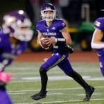 Lake Stevens’ Kolton Matson rolls out of the pocket behind his line while looking to throw downfield against Glacier Peak on Friday, Oct. 28, 2022, at Lake Stevens High School in Lake Stevens, Washington. (Ryan Berry / The Herald)