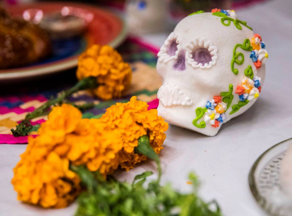 Orange cempasuchils and sugar skulls cover an ofrenda on display on Saturday at the Washington-Guerrero Foundations Día de los Muertos event at the Lynnwood Convention Center. (Olivia Vanni / The Herald)