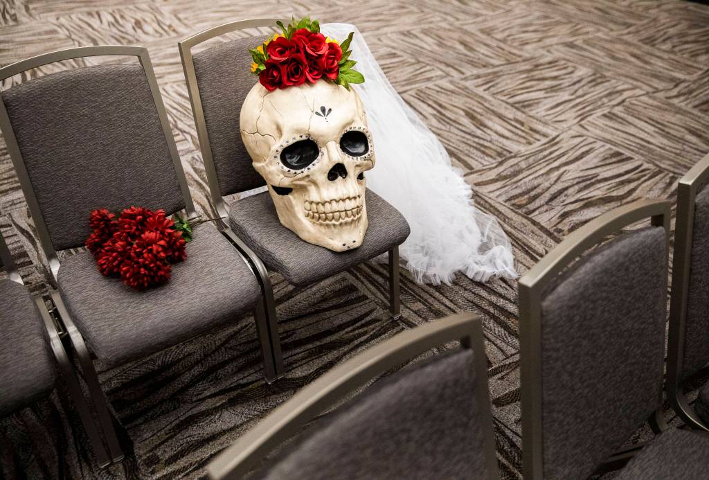 A large decorative skull with roses and a veil occupies an empty seat during the Washington-Guerrero Foundations Día de los Muertos event at the Lynnwood Convention Center on Saturday, in Lynnwood. (Olivia Vanni / The Herald)