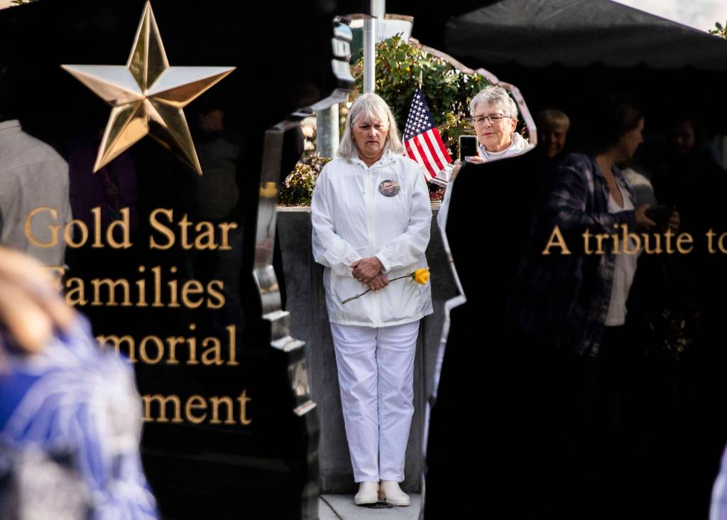 Gold Star Mother Gale Wozencraft is framed by a solider silhouette while she takes time to reflect on the life of her son, Sergeant Joel Lewis, who was killed in 2007 while deployed in Iraq on Wednesday, in Lynnwood. (Olivia Vanni / The Herald)