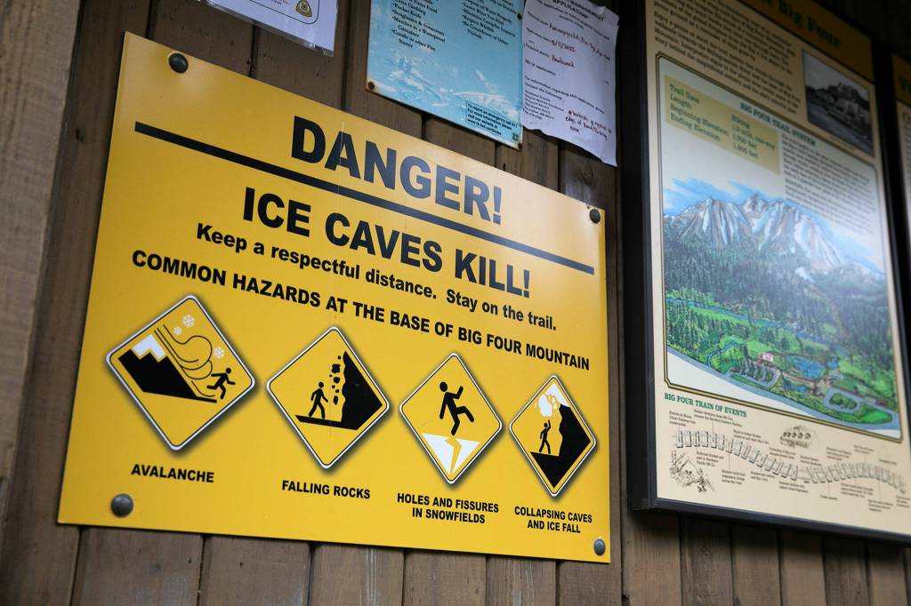 A sign warns hikers of the dangers of the Big Four Ice Caves on Oct. 28, in Mount Baker-Snoqualmie National Forest near Granite Falls. (Ryan Berry / The Herald)