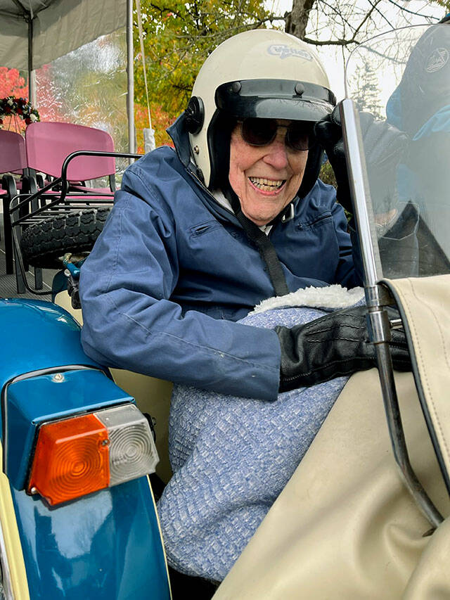 Russ Hupe rides in a sidecar alongside Snohomish County Executive Dave Somers's Ural Deco 750 motorcycle while serving as grand marshal in Mill Creek's Veterans Day parade on Friday, Nov. 11, 2022.
