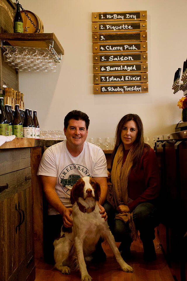 Jeff Stoner, left, Kim Taylor and their dog Tate. Greenbank Ciderys taproom is dog friendly. (Rachel Rosen / Whidbey News-Times)