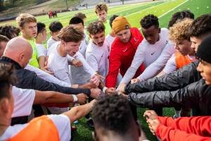 The Everett Community College soccer team sheers together before the start of their game against Whatcom on Sunday, Oct. 23, 2022 in Everett, Washington. (Olivia Vanni / The Herald)