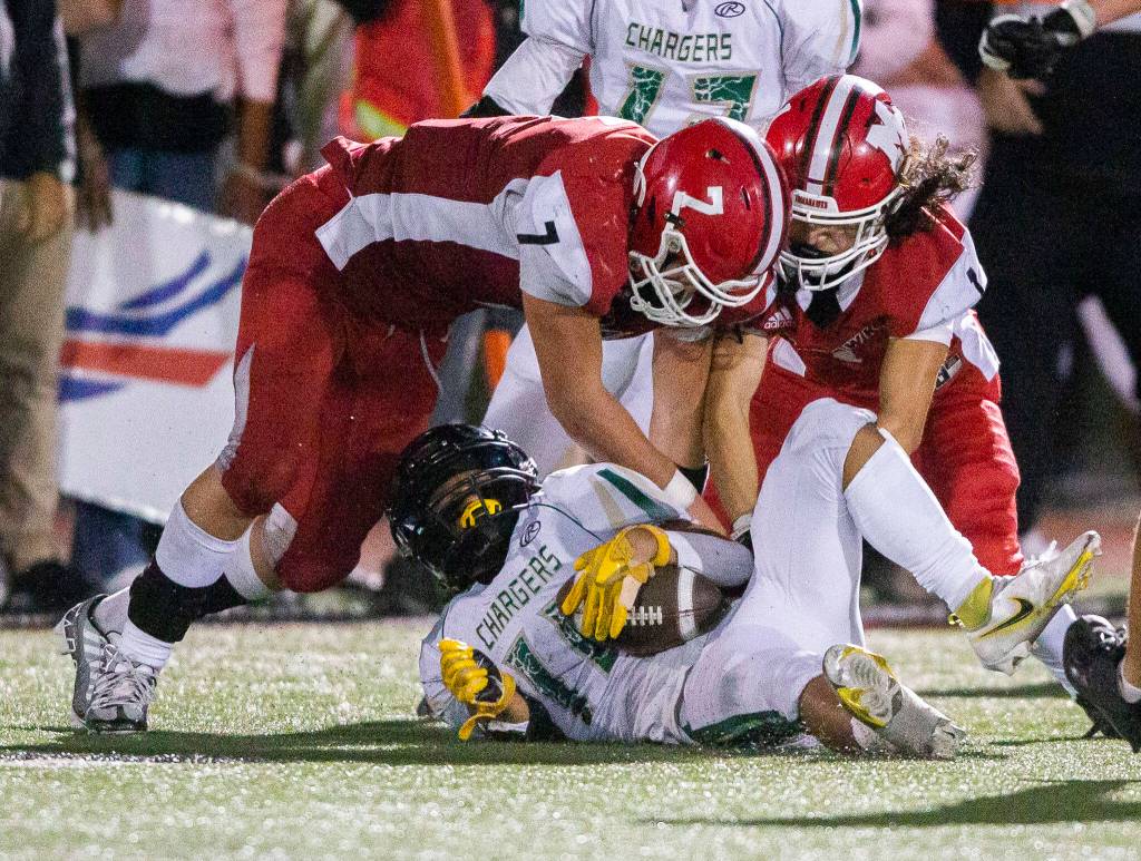 Marysville Pilchucks Christian Van Natta and Miguel Chavez tackle Marysville Getchells Dylan Padilla during the game Sept. 16 at Quil Ceda Stadium in Marysville. The Tomahawks head south to square off with Lincoln (Tacoma) on Friday. (Olivia Vanni / The Herald)