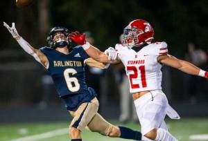 Arlington’s Kaleb Adams reaches out for a pass during the Stilly Cup against Stanwood on Friday, Sept. 30, 2022 in Arlington, Washington. (Olivia Vanni / The Herald)