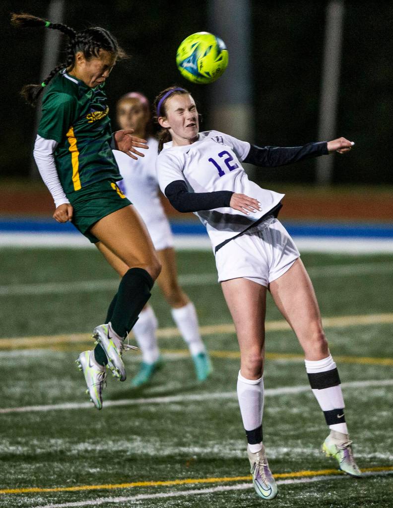 Oak Harbors Carly VanGiesen and Shorecrests Tayvi Khann both jump for a head ball during game on Tuesday, Nov. 1, 2022 in Shoreline, Washington. (Olivia Vanni / The Herald)
