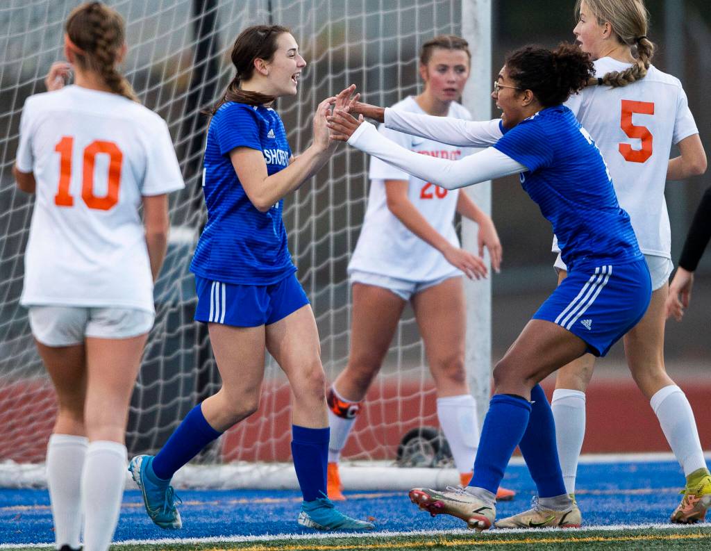 Shorewoods Diana Tuilevuka, right, runs to congratulate teammate Molly McGeoy on her goal during game against Monroe on Tuesday, Nov. 1, 2022 in Shoreline, Washington. (Olivia Vanni / The Herald)