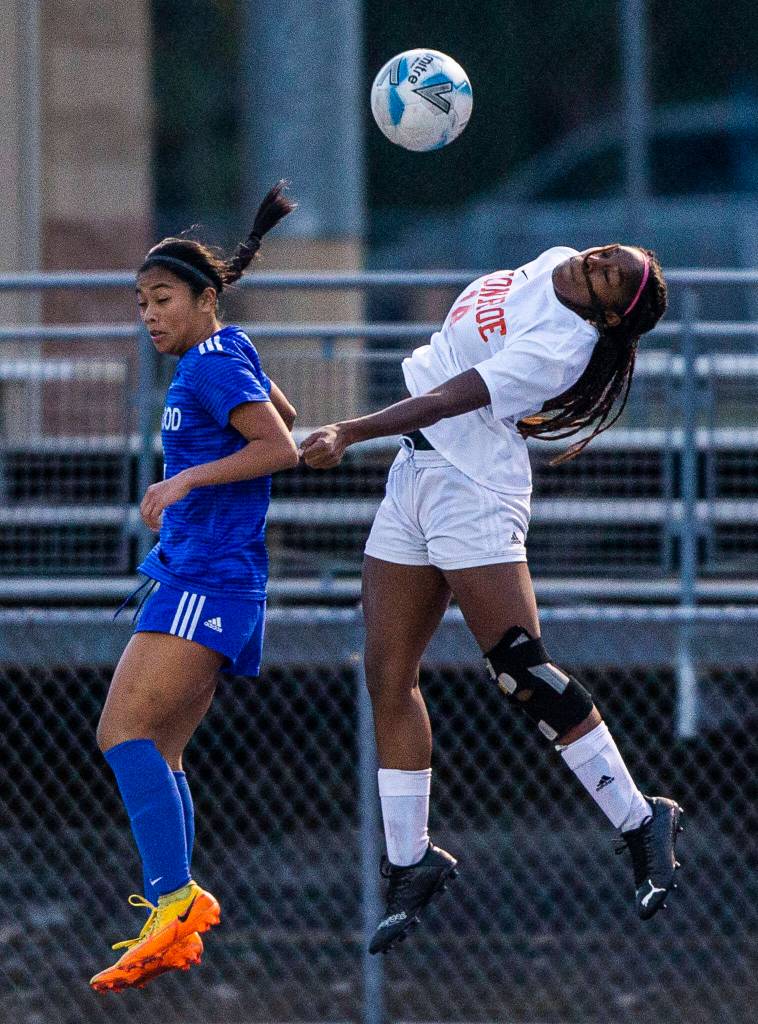 Monroes Halle Keller leaps for a head ball during game against Shorewood on Tuesday, Nov. 1, 2022 in Shoreline, Washington. (Olivia Vanni / The Herald)