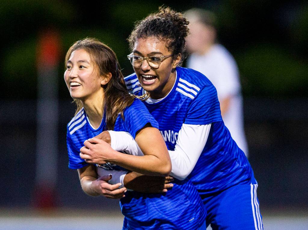 Shorewoods Diana Tuilevuka, right, hugs teammate Cary Tanaka after she scores during game against Monroe on Tuesday, Nov. 1, 2022 in Shoreline, Washington. (Olivia Vanni / The Herald)