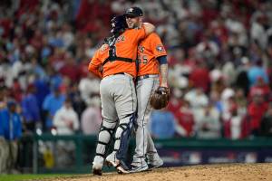 Houston Astros relief pitcher Ryan Pressly and catcher Christian Vazquez celebrate their win in Game 4 of baseball's World Series between the Houston Astros and the Philadelphia Phillies on Wednesday, Nov. 2, 2022, in Philadelphia. The Astros won 5-0 to tie the series two games all. (AP Photo/David J. Phillip)