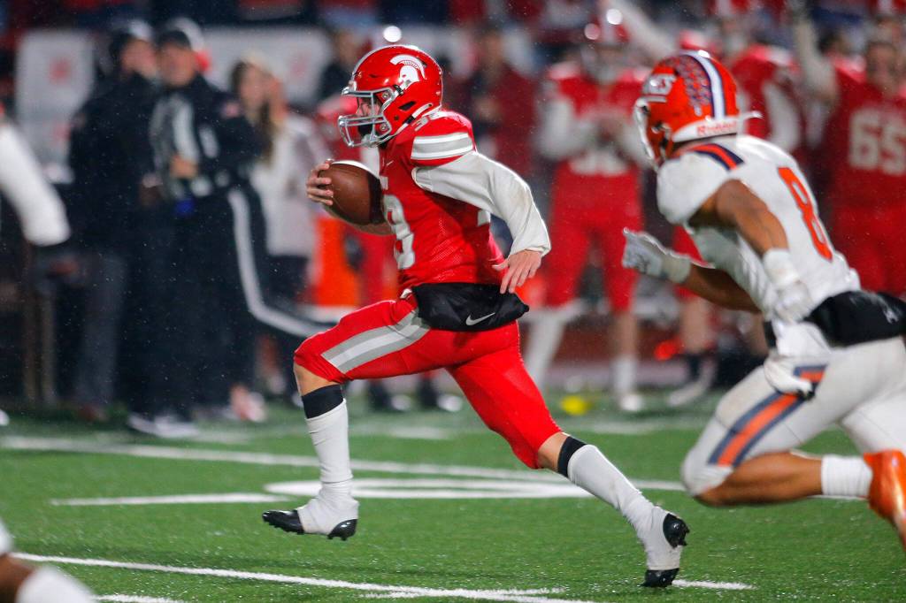 Stanwoods Carson Beckt tries to outrun the defense before getting pushed out around the 10 yard line against Lakes High School on Friday, Nov. 4, 2022, at Stanwood High School in Stanwood, Washington. (Ryan Berry / The Herald)