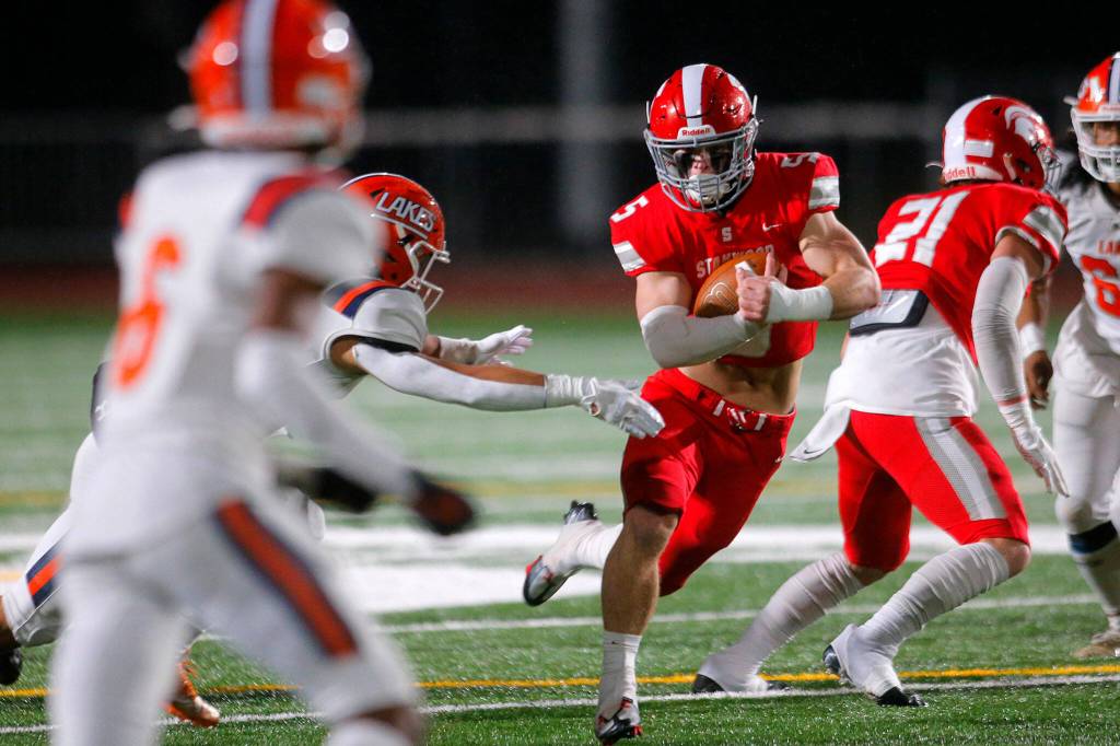 Stanwoods Ryder Bumgarner weaves through the defense against Lakes High School on Friday, Nov. 4, 2022, at Stanwood High School in Stanwood, Washington. (Ryan Berry / The Herald)