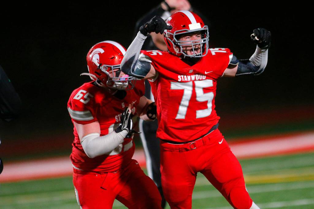 Stanwoods Carter Kinney celebrates a sack against Lakes High School on Friday, Nov. 4, 2022, at Stanwood High School in Stanwood, Washington. (Ryan Berry / The Herald)