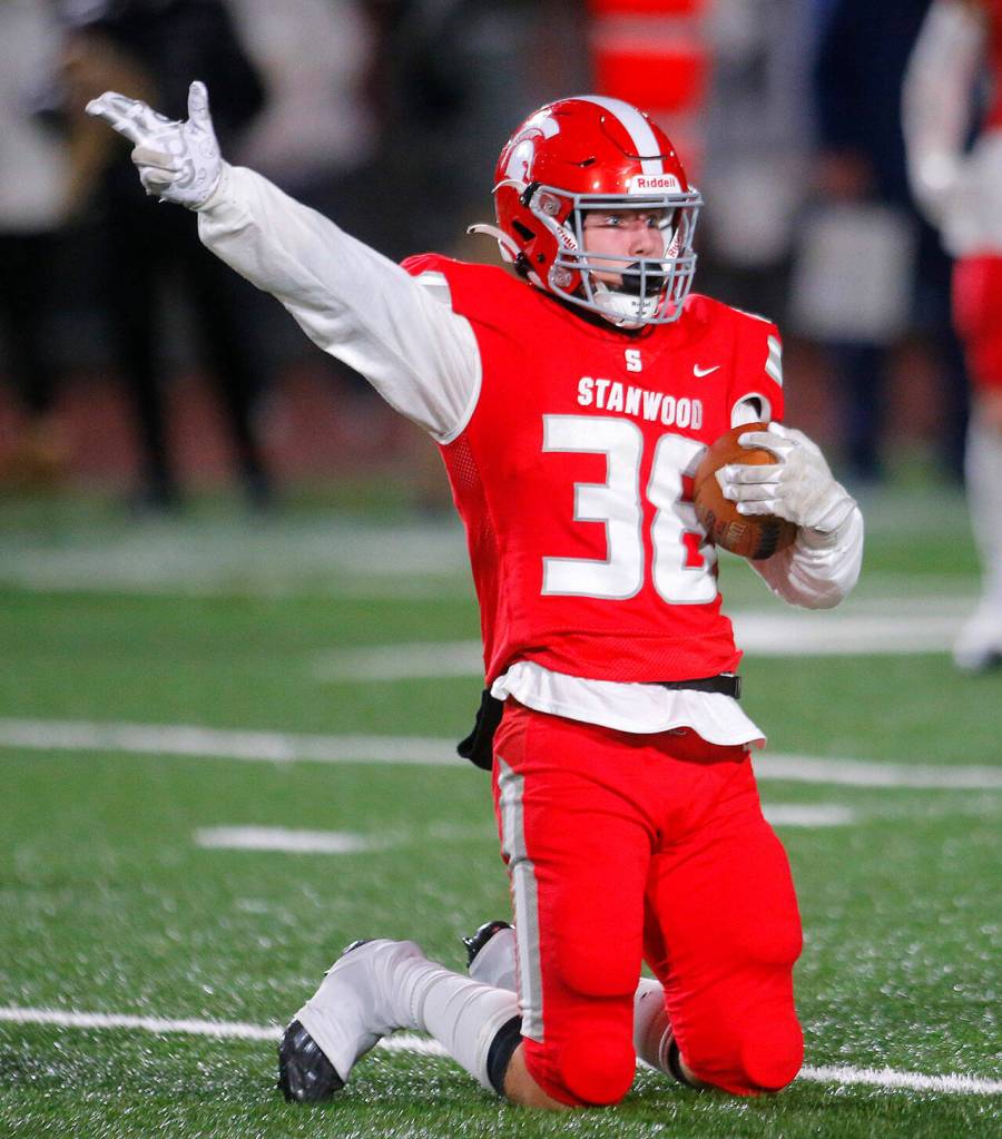 Stanwoods Carson Beckt signals for a first down after holding onto a pass through hard contact against Lakes High School on Friday, Nov. 4, 2022, at Stanwood High School in Stanwood, Washington. Targeting was called on the play, resulting in extra yards for Stanwood. (Ryan Berry / The Herald)