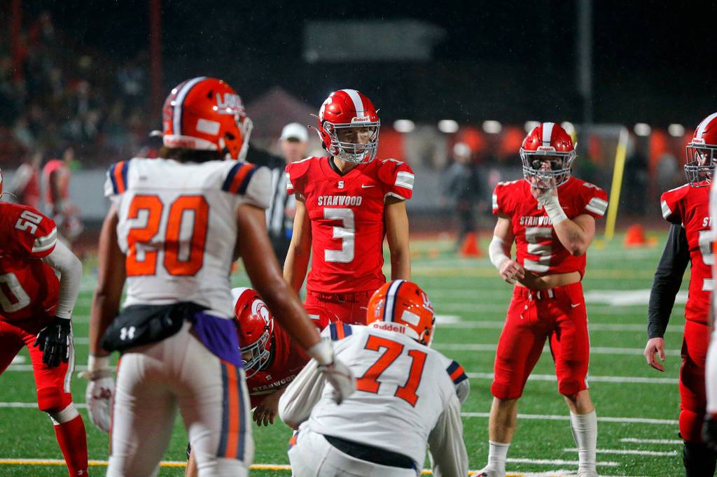 Stanwoods Wyatt Custer surveys the field in the second half after coming in as a replacement quarterback for the injured Michael Mascotti against Lakes High School on Friday, Nov. 4, 2022, at Stanwood High School in Stanwood, Washington. (Ryan Berry / The Herald)