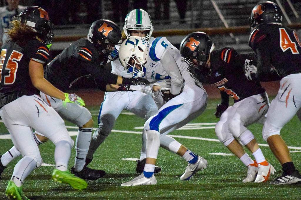 A gang of Monroe defenders take down Libertys Jaxson Thoresen on Friday, Nov. 4, 2022 in Monroe, Washington. (Katie Webber / The Herald)