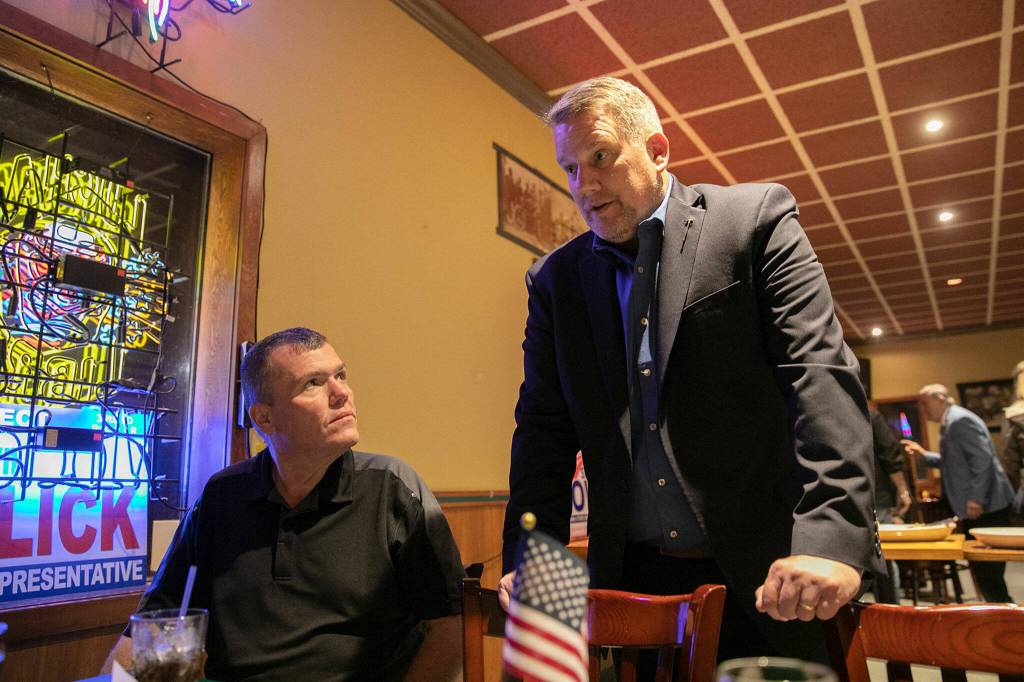 Sam Low fills in a group of supporters on the expected timeline of results during a midterm election night watch party on Tuesday, at Papas Mexican Grill in Lake Stevens. (Ryan Berry / The Herald)