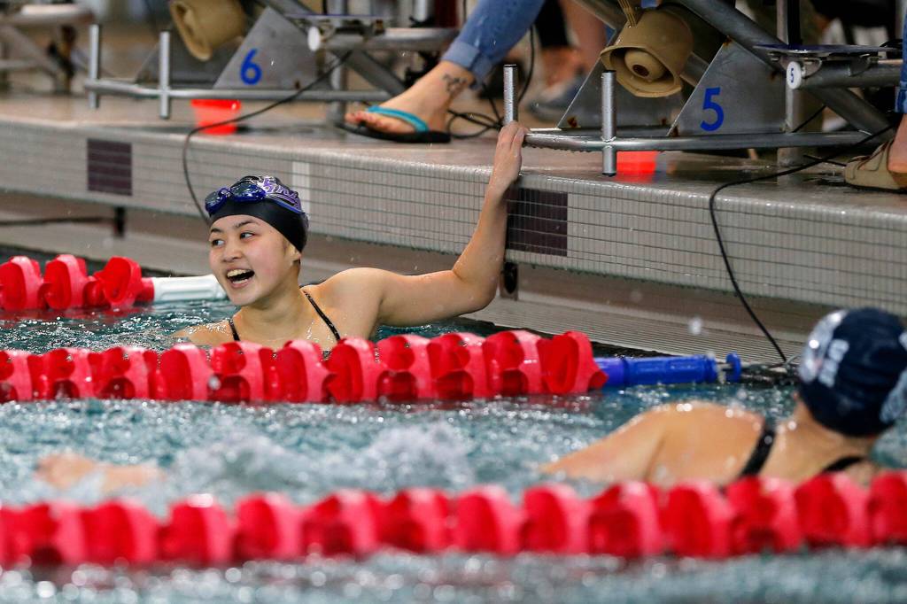 Kamiak sophomore Janey Ryu cracks a smile after winning the girls 500 yard freestyle during the Class 4A District 1 swim meet Saturday, Nov. 5, 2022, at Snohomish Aquatic Center in Snohomish, Washington. (Ryan Berry / The Herald)