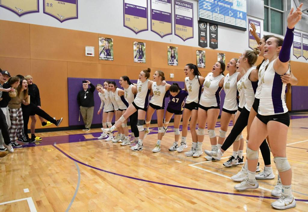 The Lake Stevens volleyball team sways and sings along with fellow Ltudents to the sounds of the Neil Diamond song Sweet Caroline following their win over Bothell in a 4A District 1/2 Tournament match on Nov. 8, 2022, in Lake Stevens. (John Gardner / Pro Action Image)